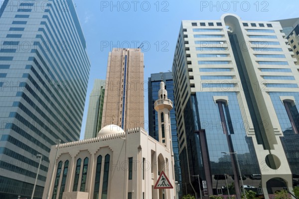 Abu Dhabi, United Arab Emirates. June 23rd 2019 A mosque among modern glass fronted office