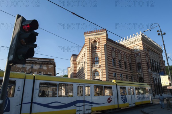 Sarajevo, Bosnia and Herzegovina. July 24th 2019 A tram passing Sarajevo City Hall, known as