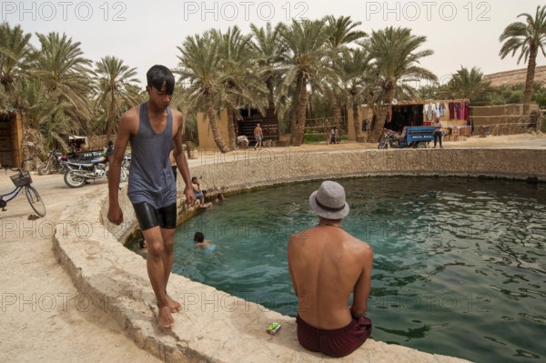 Siwa Oasis, Egypt. April 12th 2018. Young Egyptian men hang out and swim at Cleopatras Pool, Siwa
