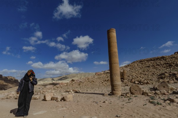 Petra, Jordan. December 11th 2012 A Jordanian Bedouin woman near a monument known as the Pharaohs