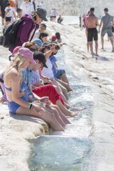 Pamakkule, Turkey, April 25th 2020 Tourists soak their feet in the thermal waters of the Travertine