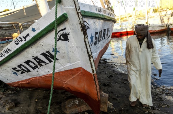 Aswan Egypt. January 12th 2013 Nubian Felucca captain with his sail boat on Elephantine Island