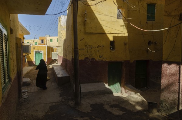 Aswan, Egypt. 10th January 2013 A local Muslim women walking in the narrow alleyways of a Nubian