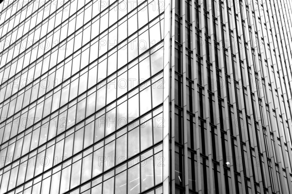 Modern black and white graphic image of abstract reflections in glass fronted commercial office