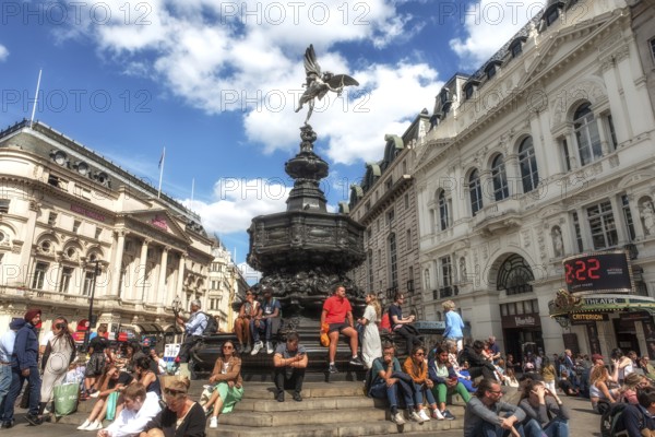 London, United Kingdom, June 28th 2022 Tourists sitting on the steps of the Shaftesbury Memorial