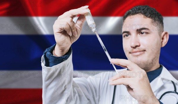 Doctor holding syringe on Thailand flag background. Medical professional holding syringe with Thai