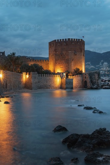 Beautiful evening view of Alanya Harbour and the Red Tower with the Taurus Mountains and