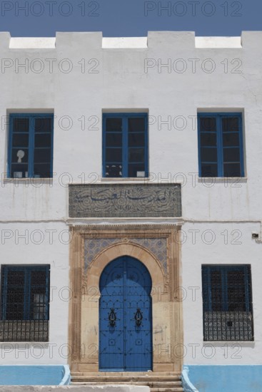 The beautiful blue ornate door and architecture of the Abbasid School inside the Medina of Sfax,