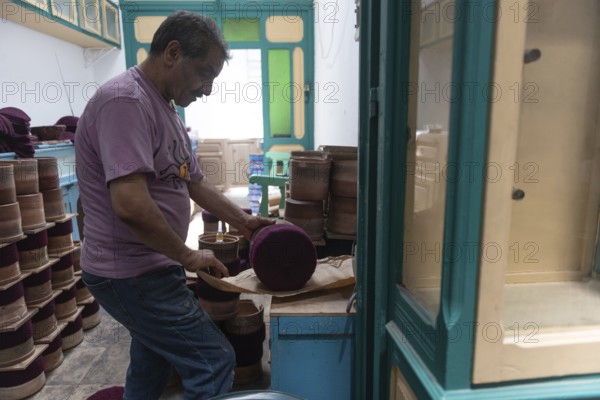 Tunis, Tunisia 22nd May, 2024 A Tunisian artisan uses an iron in the making of the traditional