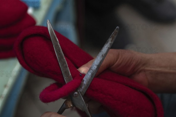 Tunis, Tunisia 22nd May, 2024 A Tunisian artisan puts the finishing touches to a red Chechia in