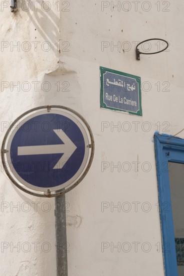 A one-way blue street sign on Rue de la Carriere, one of the many narrow streets of Tunis Medina, a