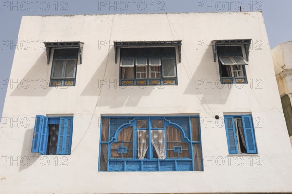 Classic white washed walls and blue painted windows of Tunisian architecture in the UNESCO world