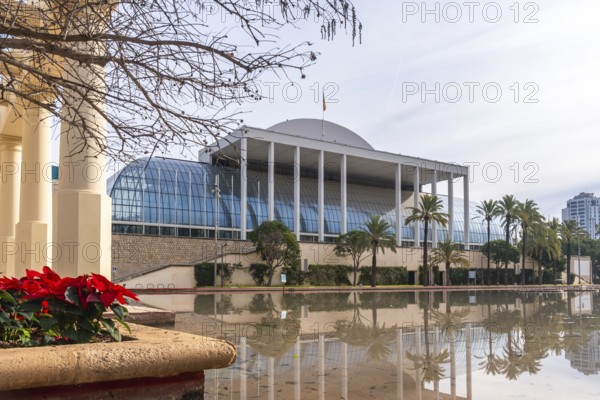 Palau de la musica, a modern concert hall featuring a glass facade and white columns, reflecting on