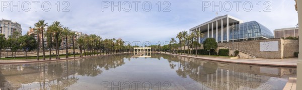 Palau de la musica, a modern architectural landmark, reflecting in the tranquil waters of the turia