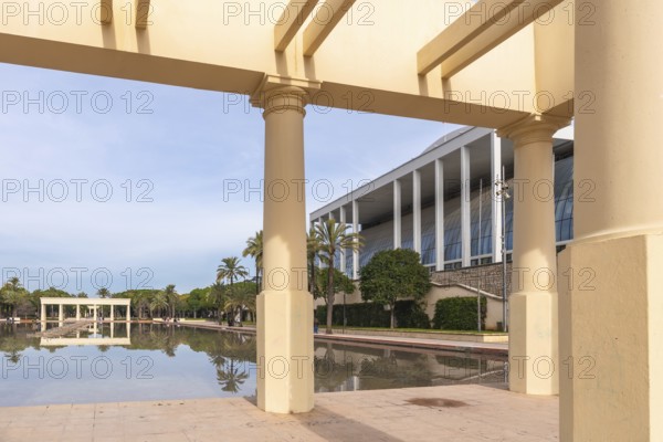 Palau de la musica building's modern architecture contrasts with classical columns of a pergola