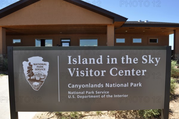 Island in the Sky Visitor Center sign in Canyonlands National Park in front of the center,