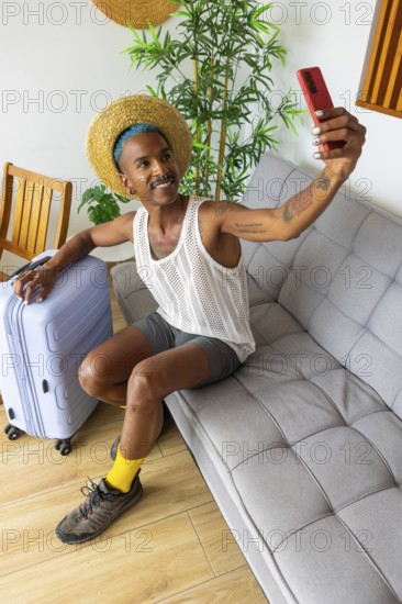 A stylish LGBTQIA+ man prepares for vacation, taking a selfie while holding luggage. The scene