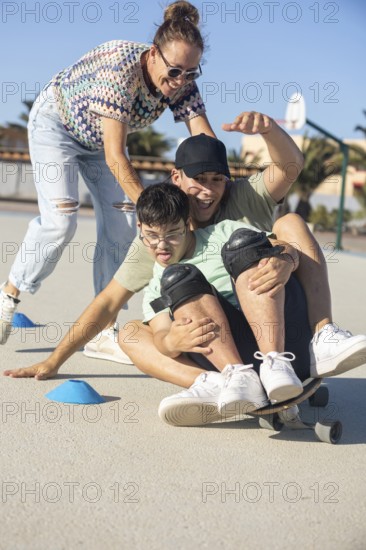 A Down syndrome teenager enjoys a playful skateboard ride with family support in an outdoor setting