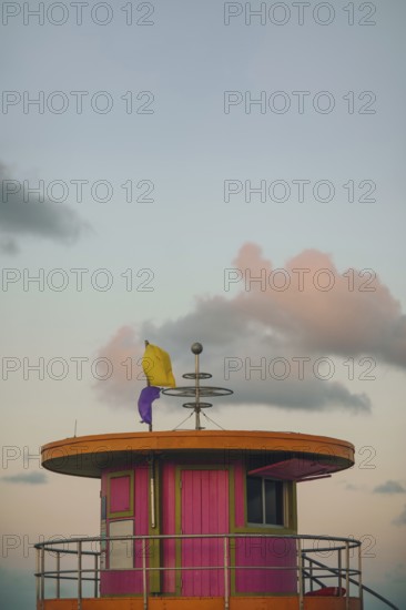 A picturesque view of a vibrant, colorful lifeguard tower on Miami Beach, captured under a softly