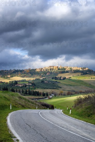 A scenic view of Pienza from the main road in Val d Orcia, Tuscany. The winding road cuts through