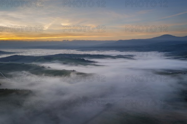 A stunning aerial view of the Val d Orcia in Tuscany, Italy, with rolling hills blanketed in