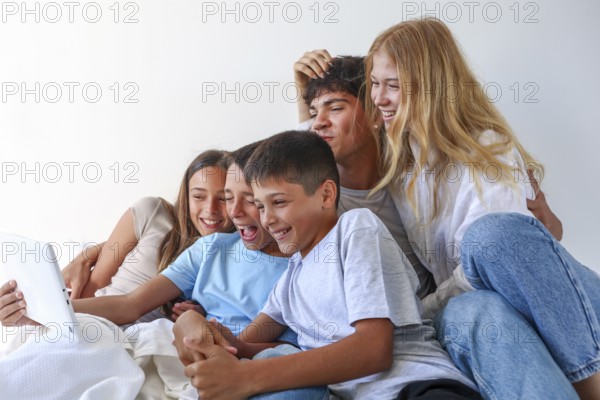 A joyful moment at home with five siblings, an older brother and sister with their younger triplet