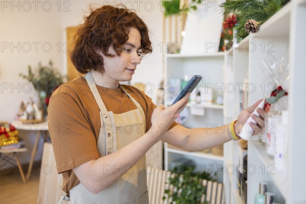 Retail worker using a smartphone to scan a product in a well-lit, contemporary store The scene is