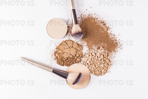 Top view image showcasing a selection of makeup powders including compact and loose varieties,