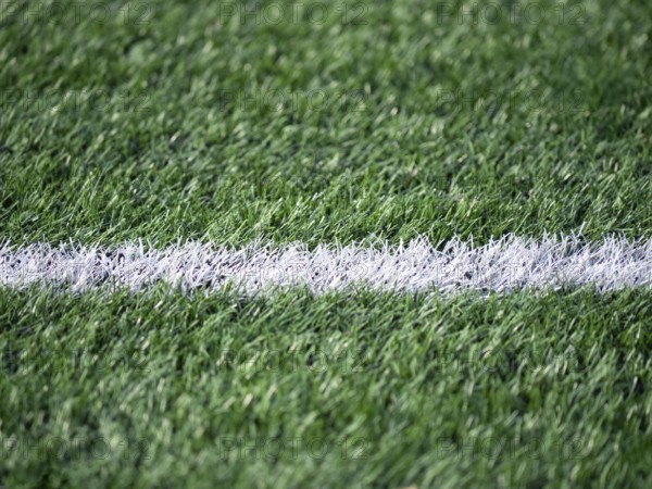 Detailed shot of a soccer field, highlighting the contrast between the vibrant green grass and a