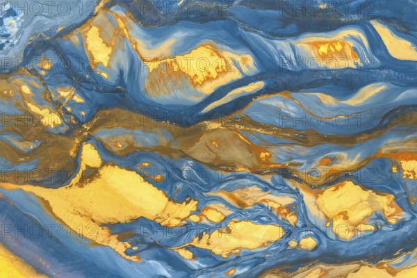 This image captures a stunning blend of swirling blue and gold hues, creating an abstract texture