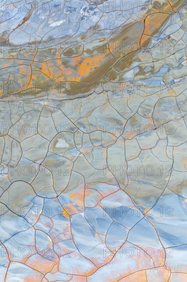 Multicolor cracked mud texture showcasing vibrant patterns and natural hues Abstract art created by