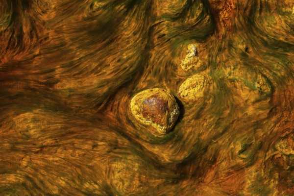 Close-up of the mineral-rich waters in Riotinto, Huelva, Spain, showcasing the vibrant orange and