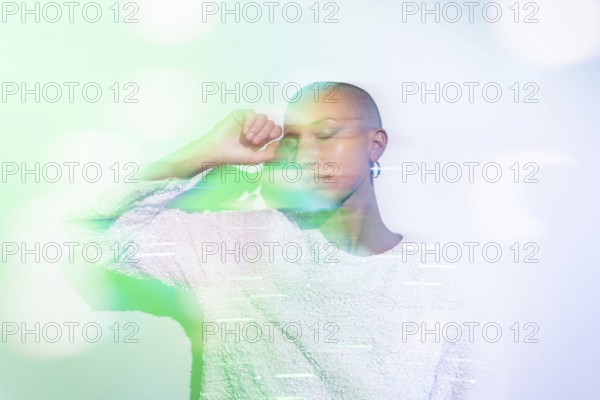 A serene image of a middle-aged woman with a shaved head, wearing a textured white top against a