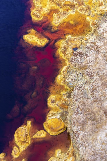 Aerial view of Riotinto River in Huelva, Spain, showcasing vivid red, orange, and blue hues The