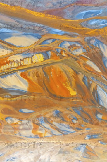 A striking multicolor abstract texture showcasing dynamic flowing patterns in vivid orange, blue,
