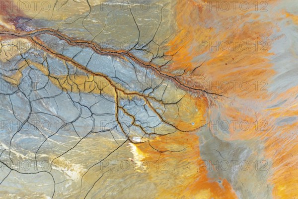 Aerial perspective of vibrant multicolor mud patterns and textures The image showcases natural,