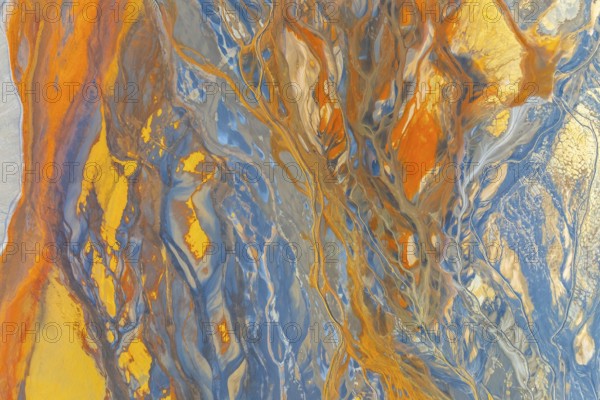 A vibrant abstract image showcasing dynamic swirling patterns in blue, orange, and yellow hues The