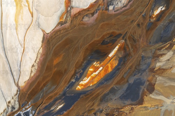 Abstract texture featuring swirling earthy tones intermixed with vibrant orange, cream, and teal