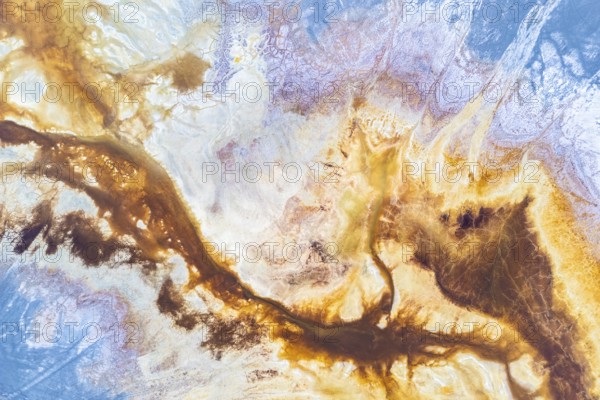 A vibrant abstract texture blending earthy browns and celestial blues, evoking landscapes and