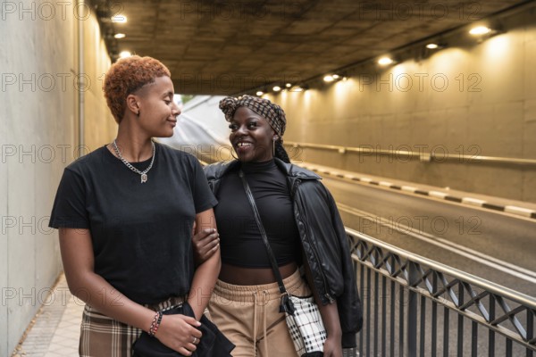 An LGBT multiethnic couple shares a joyful moment while strolling through an illuminated urban