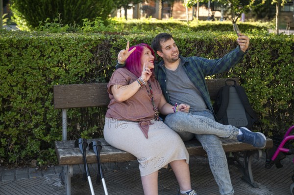 A college couple sitting on a bench, capturing a joyful moment together The woman uses crutches,