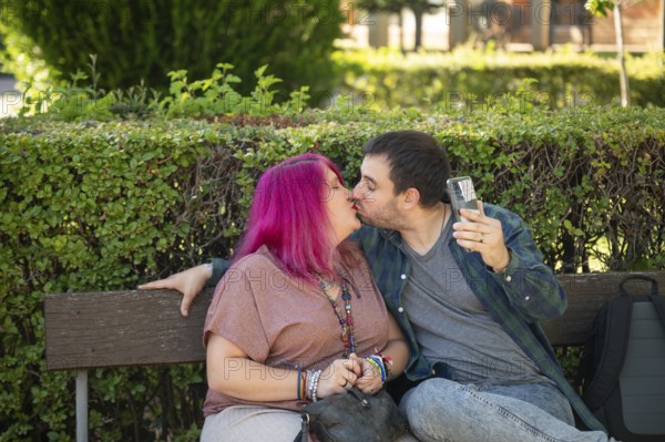 A college couple shares a tender kiss on a campus bench The woman, embracing life with a disability