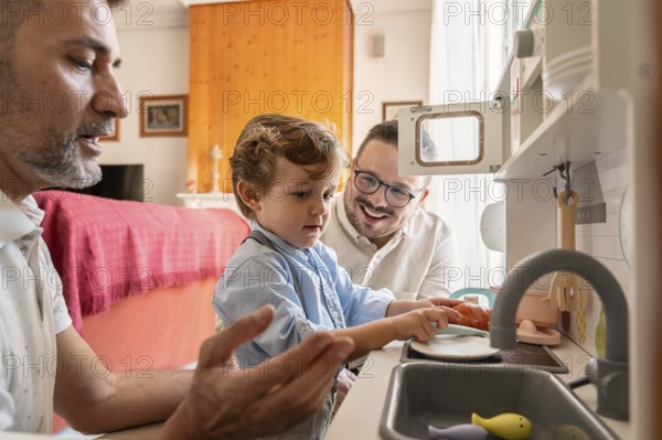 A joyful gay couple shares a bonding moment with their son as they engage in imaginative play at