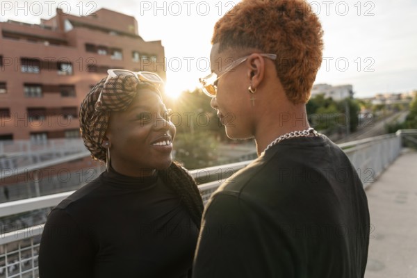 A loving LGBT multiethnic couple shares a tender moment while basking in the warm glow of the