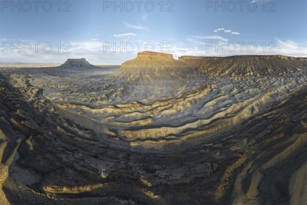 A breathtaking view of the rugged landscape of Caineville Mesa, Utah, USA, captured at sunset The
