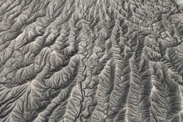 Stunning aerial photograph capturing the intricate, wavy patterns of the eroded land formations at