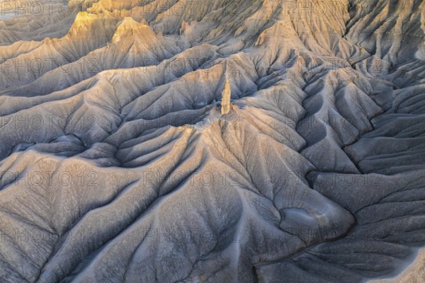 Sunrise lights up the layered hills of Caineville Mesa near Hanskville, Utah, highlighting their