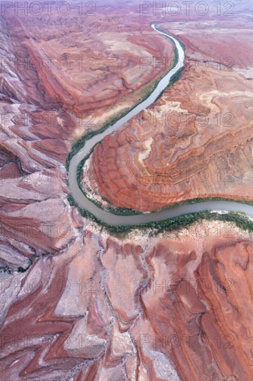 An aerial shot captures the serpentine path of Rio San Juan as it carves through the striking red