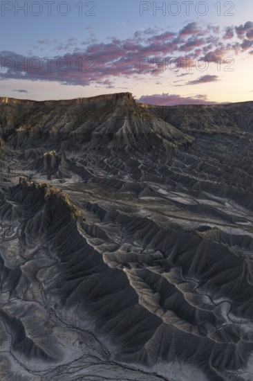 Dramatic view of Caineville Mesa in Utah at sunrise, showcasing unique geological formations and