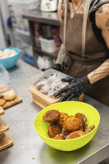 A baker at an Italian bakery prepares fresh pastries on a stainless steel countertop A vibrant
